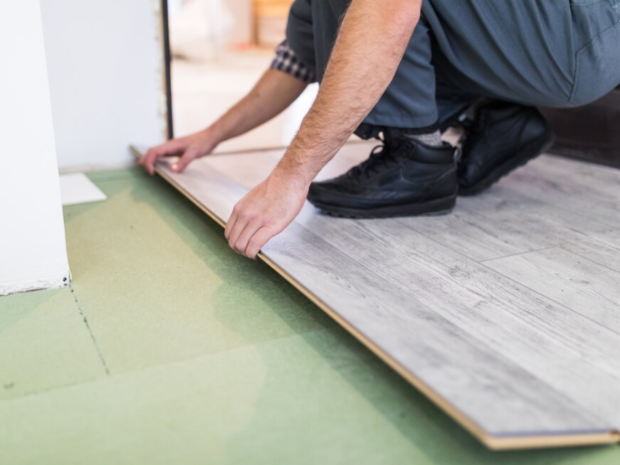 Flooring contractor installing flooring planks