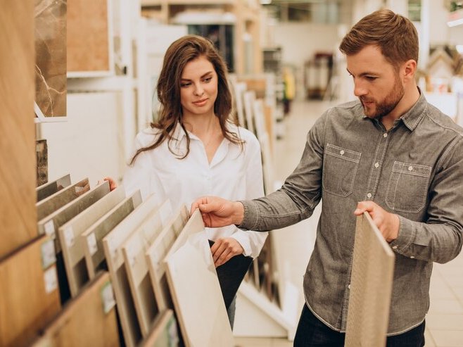 Customer looking at tile samples in a flooring showroom