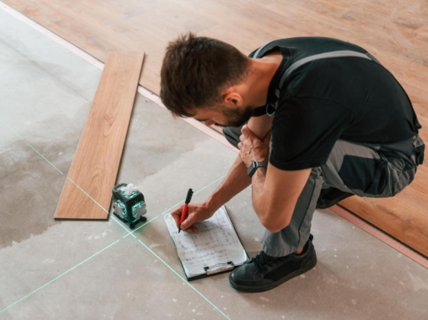 Flooring contractor installing hardwood floors